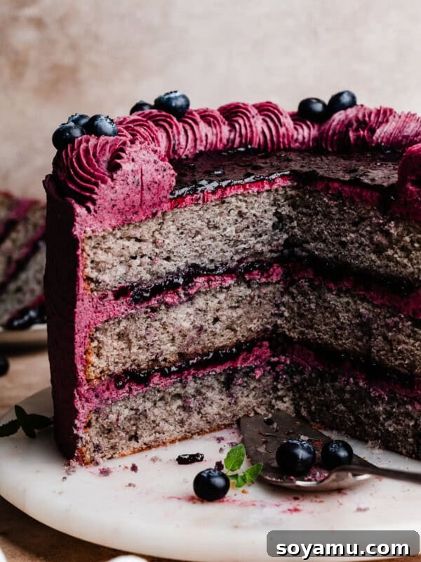 Double Blueberry Bundt Cake Recipe for Moist, Fruity Treat 17 The sliced blueberry cake on a cake plate, with stunning layers of blueberry cake, blueberry filling, and blueberry frosting.