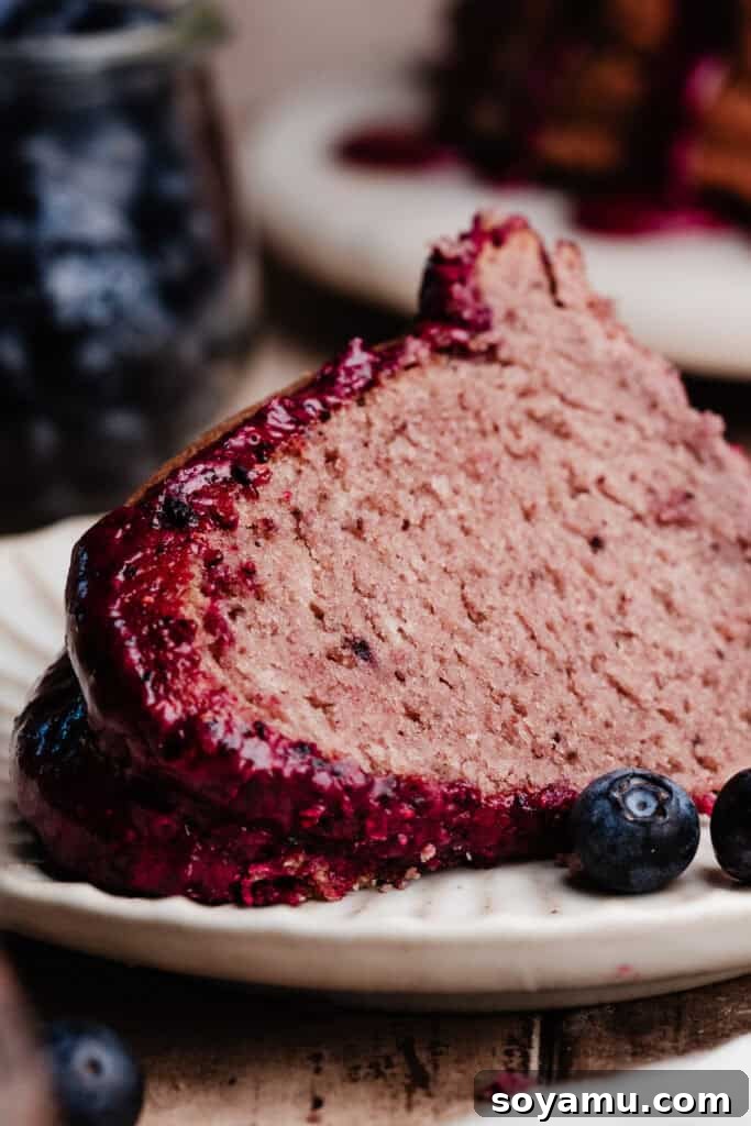 Double Blueberry Bundt Cake Recipe for Moist, Fruity Treat 3 A slice of blueberry bundt cake on a dessert plate.