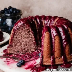 Double Blueberry Bundt Cake Recipe for Moist, Fruity Treat 21 The sliced blueberry bundt cake on a cake plate, topped with blueberry glaze.