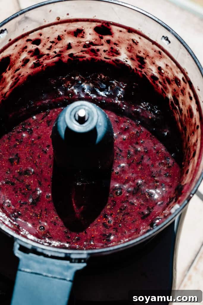 Double Blueberry Bundt Cake Recipe for Moist, Fruity Treat 4 A food processor full of blueberry liquid.