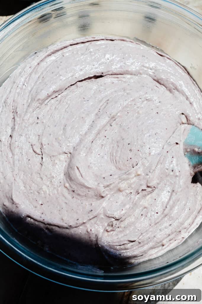 Double Blueberry Bundt Cake Recipe for Moist, Fruity Treat 10 A mixing bowl of light purple cake batter.