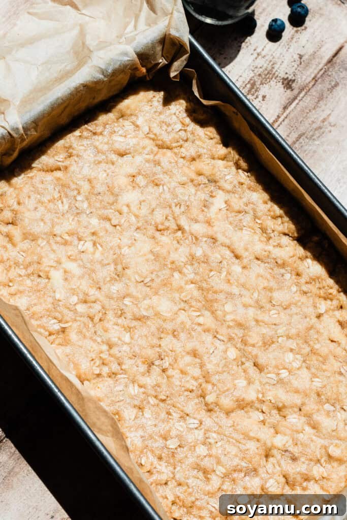 Homemade Blueberry Oat Crumble Bars 7 The pre-baked bottom crust in a 9x13 pan.
