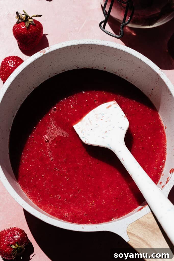 A saucepan full of the vibrant strawberry liquid.