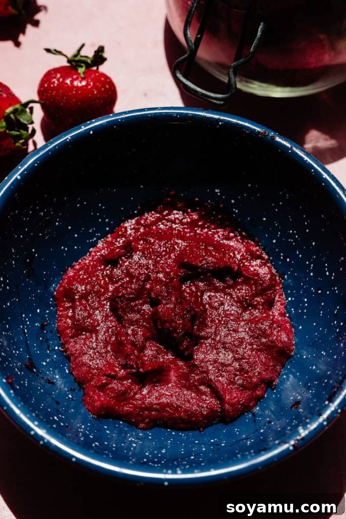 The thick strawberry reduction in a bowl.