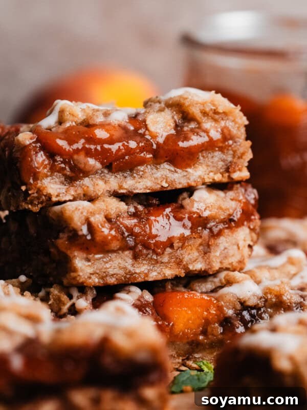 Southern-Style Peach Cobbler Muffins Recipe 19 A close-up on a stack of peach bars.