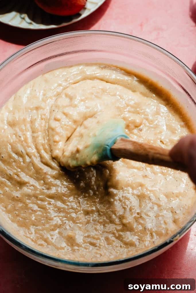 Southern-Style Peach Cobbler Muffins Recipe 8 A bowl of the muffin batter being stirred together.