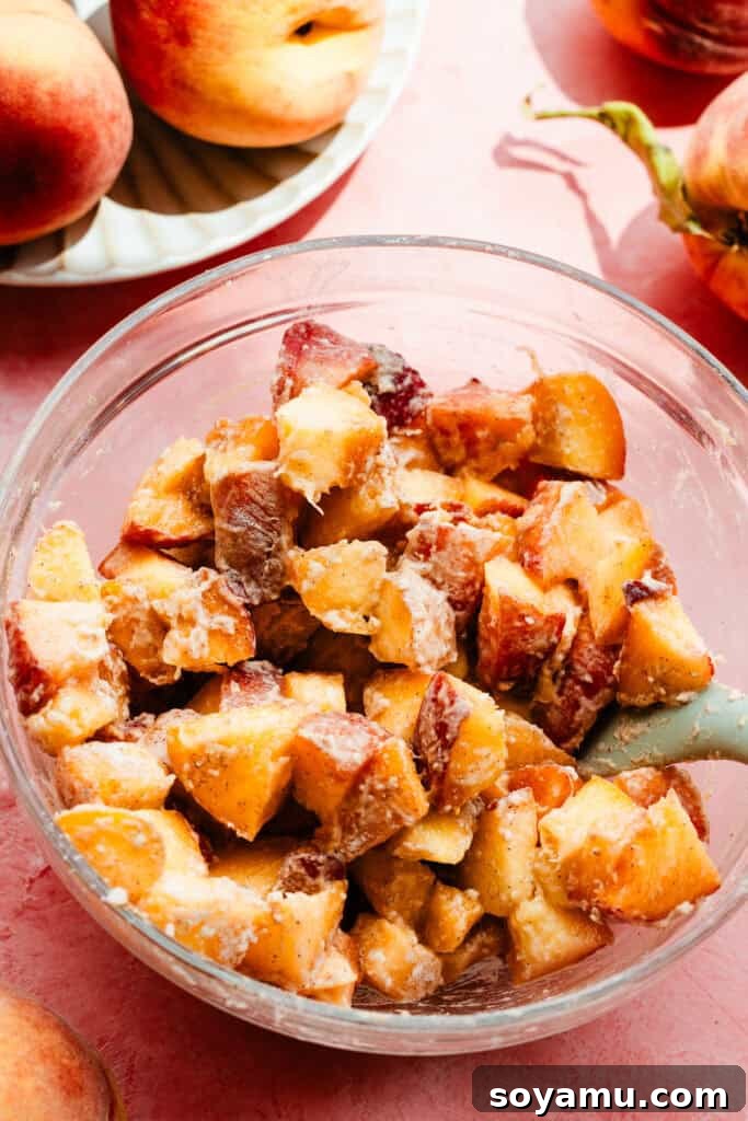 Southern-Style Peach Cobbler Muffins Recipe 9 A bowl of diced peaches tossed with a little flour.