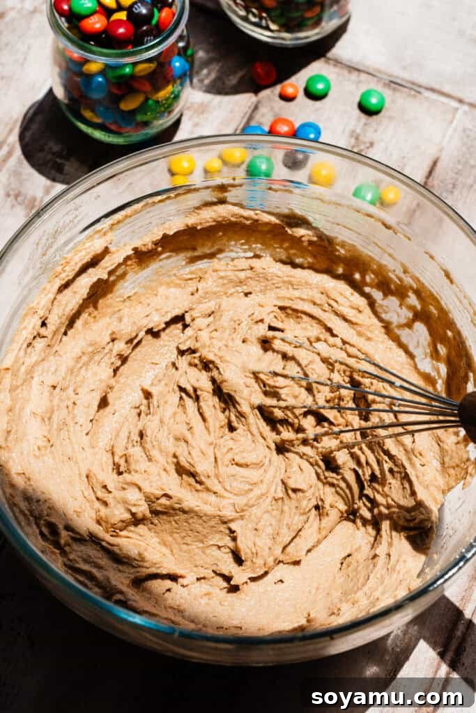 Thin, Chewy M&M Chocolate Chip Cookies 6 A bowl of the thick, slightly smooth mixture once the eggs, vanilla, and milk have been whisked in.