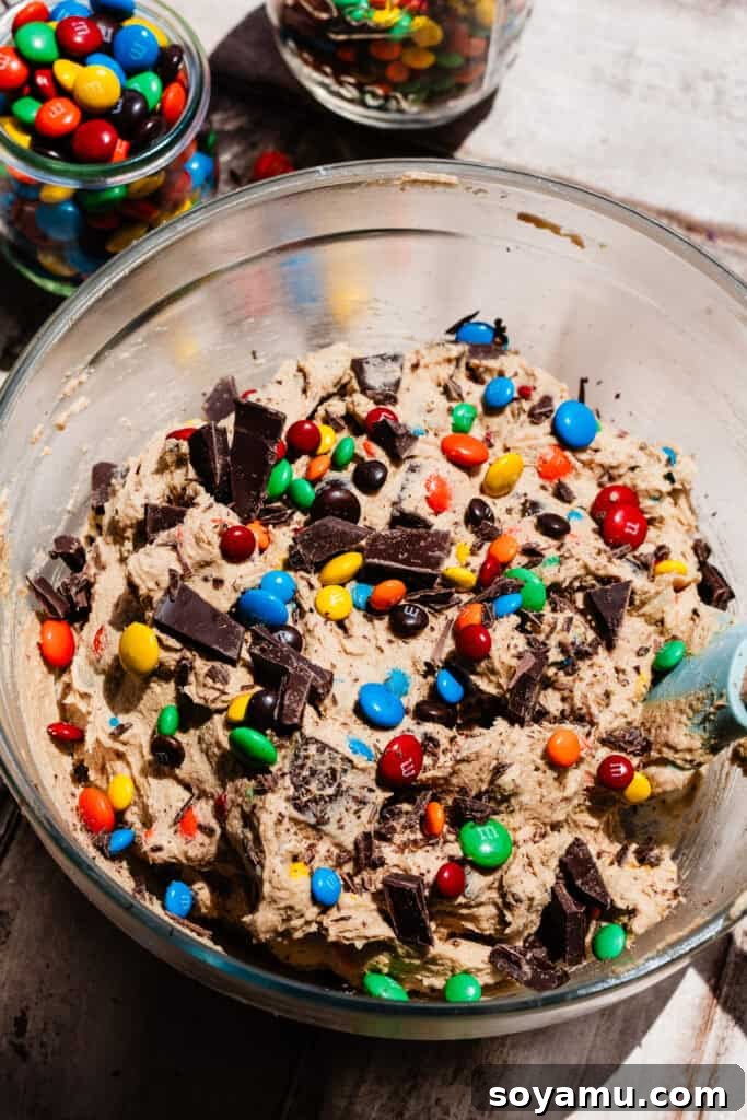Thin, Chewy M&M Chocolate Chip Cookies 8 A bowl of the dough with the chocolate chunks and m and ms mixed in.