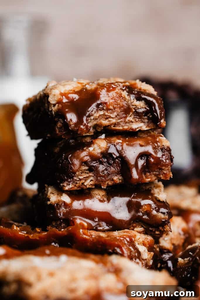 Carmelita Bars with Homemade Salted Caramel Filling 2 A close-up on a stack of the carmelitas, with melty caramel sauce dripping out of the bars.