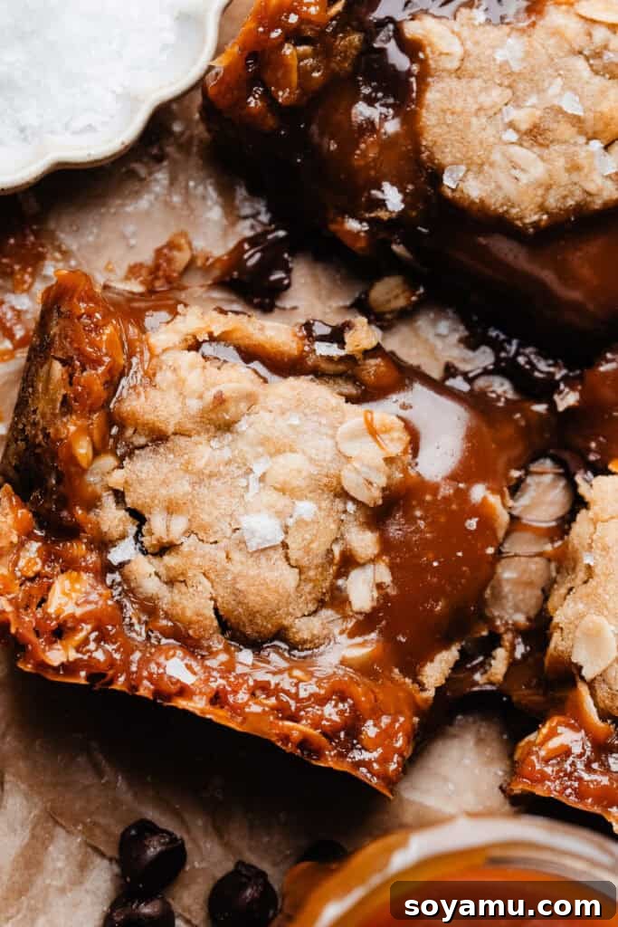 Carmelita Bars with Homemade Salted Caramel Filling 5 A close-up on a caramelita bar, with melty caramel and chocolate oozing out.