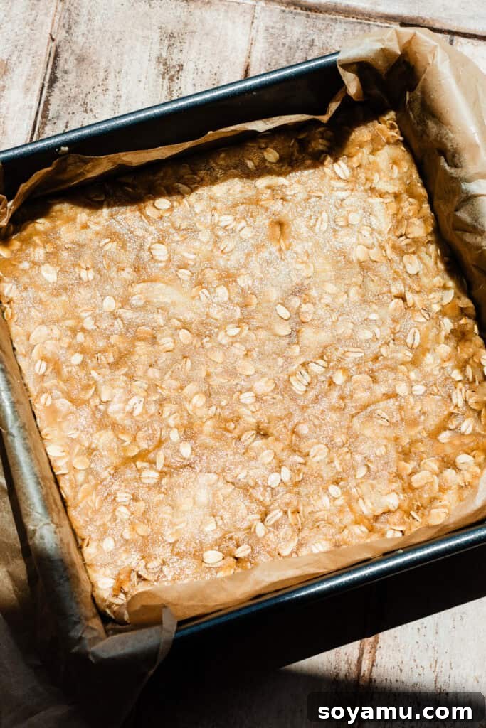Carmelita Bars with Homemade Salted Caramel Filling 7 The crust mixture pressed into a 9x9 pan, ready to be baked.