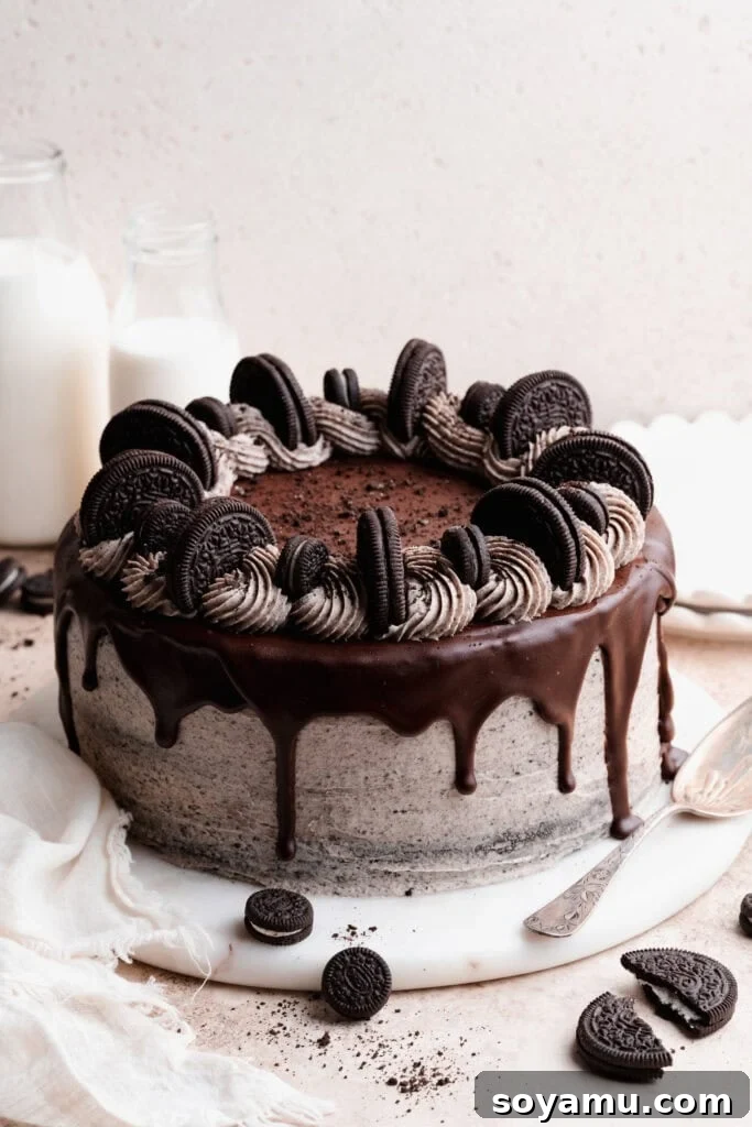 Decadent Moist Oreo Cake Recipe 15 The fully assembled, decorated cake on a marble cake plate.
