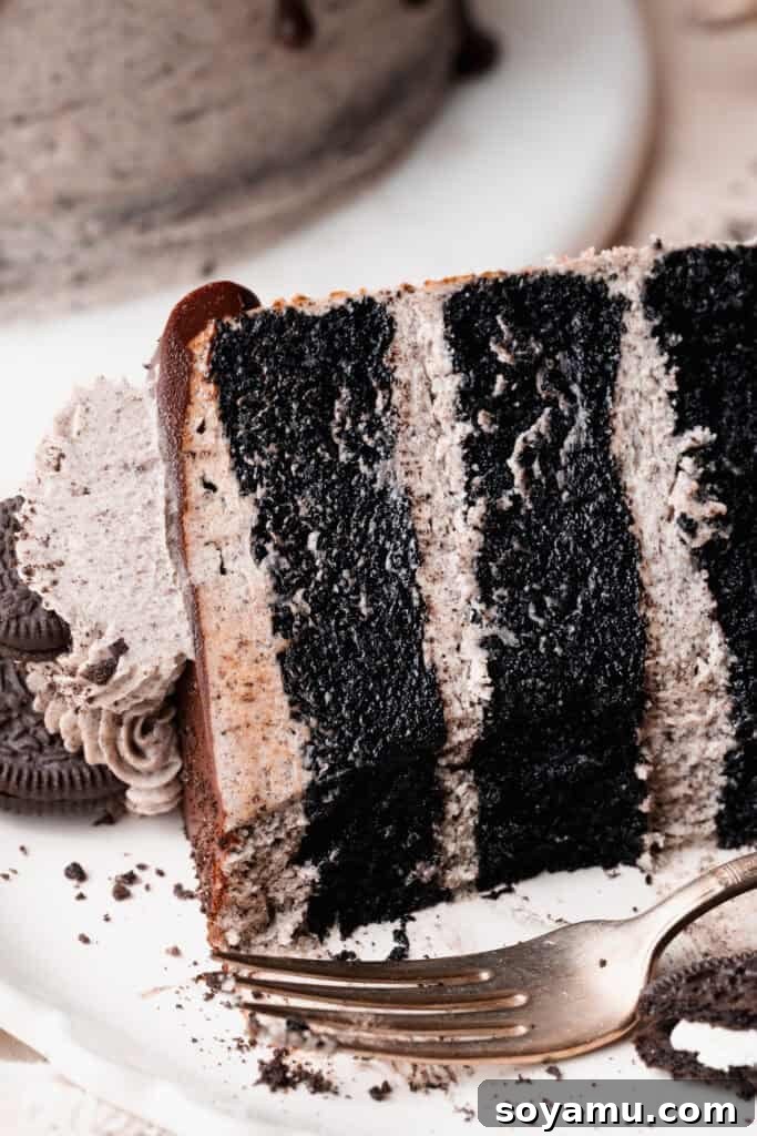 Decadent Moist Oreo Cake Recipe 16 A close-up of a slice of oreo cake, with a few bites missing.