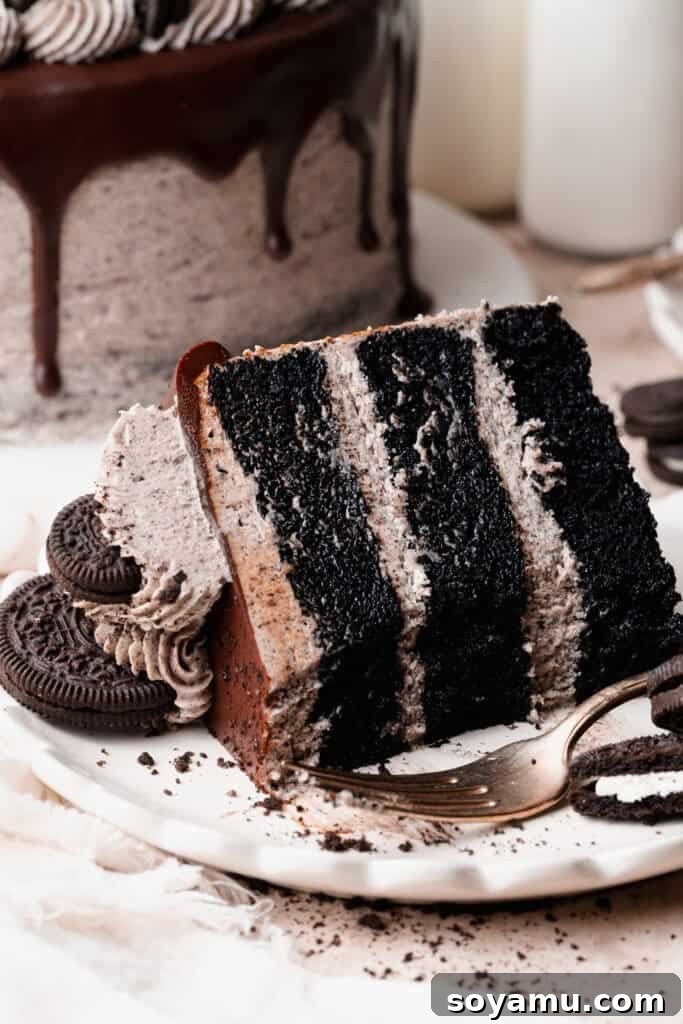 Decadent Moist Oreo Cake Recipe 4 A slice of oreo cake on a plate, with a few bites missing.