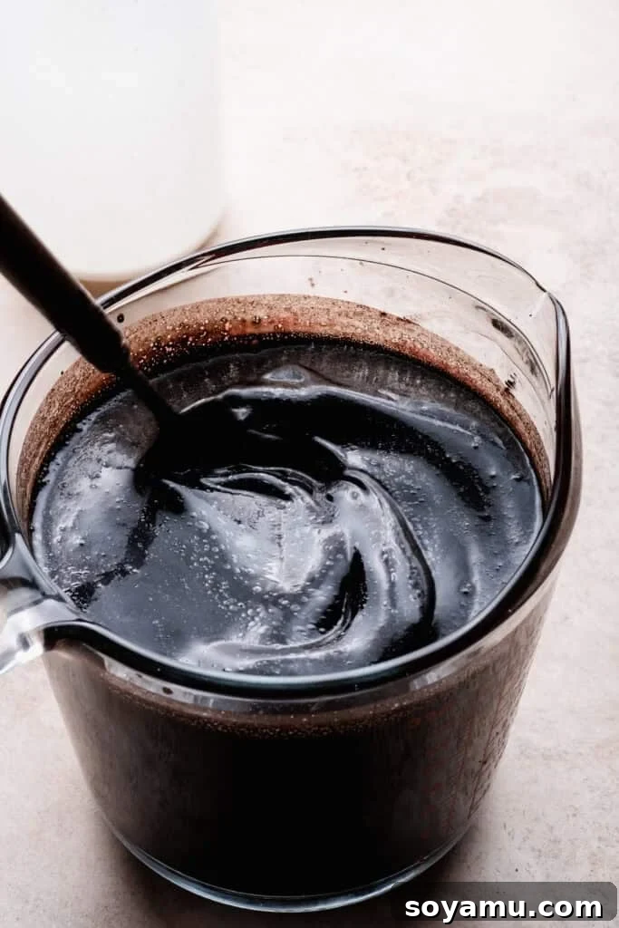 Decadent Moist Oreo Cake Recipe 6 A whisk mixing the wet ingredients together in a measuring cup.