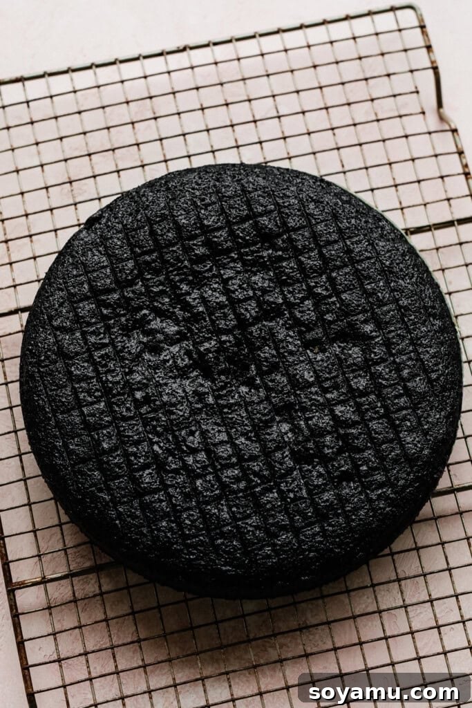 Decadent Moist Oreo Cake Recipe 10 A cake layer cooling on a cooling rack.