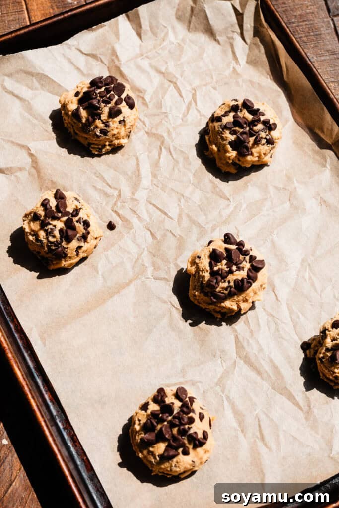 Chewy No-Chill Peanut Butter Chocolate Chip Cookies 8 Six cookie dough balls on a pan, ready to be baked.