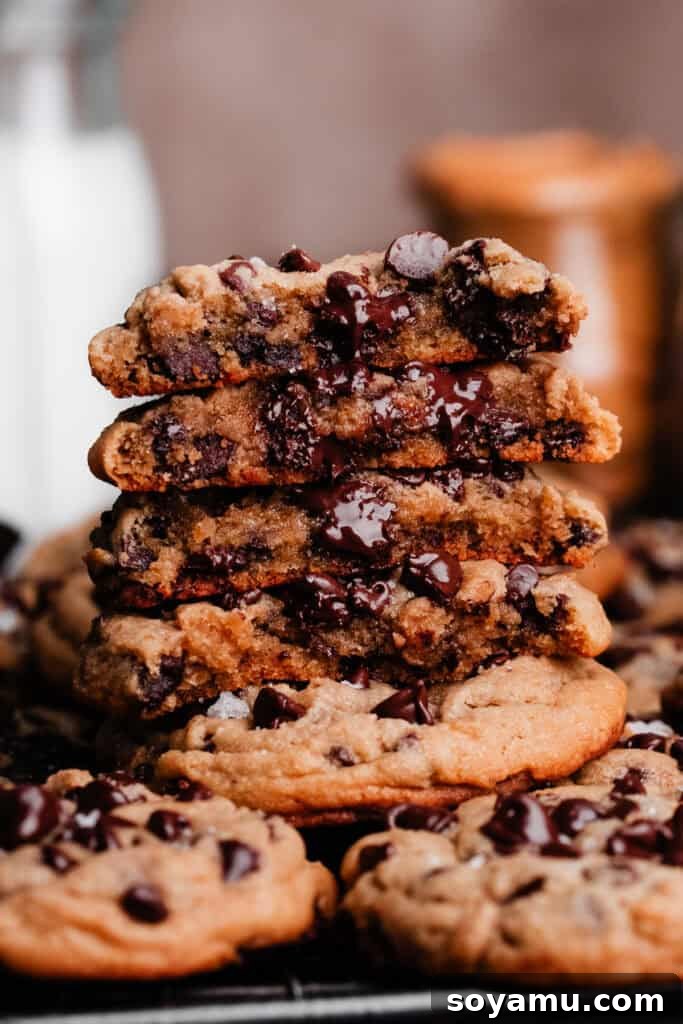 Chewy No-Chill Peanut Butter Chocolate Chip Cookies 10 A stack of peanut butter chocolate chip cookie halves, showing the gooey insides.