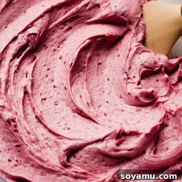 A bowl of silky, pink raspberry frosting.