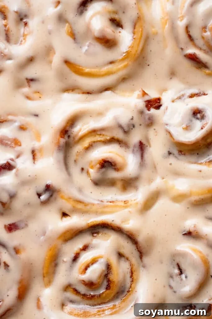 A close-up, bird's eye view of the baked, frosted cinnamon rolls.