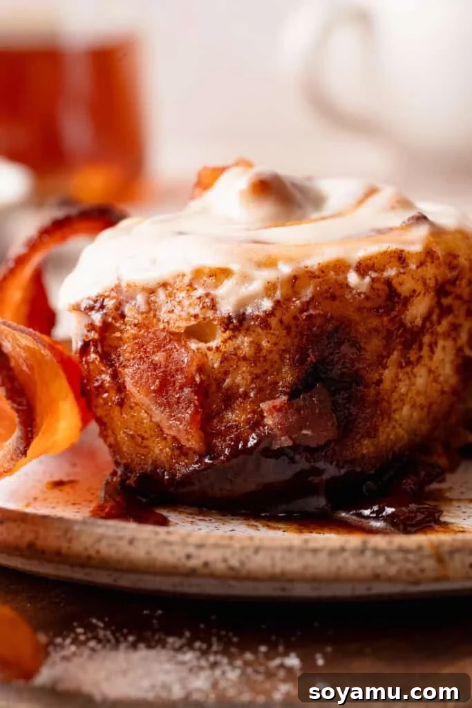 A close-up on the inside of a cinnamon roll, showing the gooey texture.
